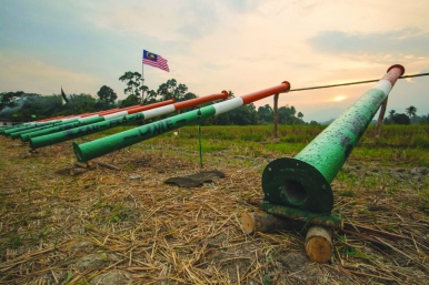 Freshly painted cannons await the setting of the sun on the eve of Eid al-Fitr